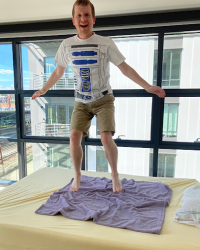 bb-living-sleepover-3 A male Best Buddie's Sleepover participant jumping up and down on his bed.