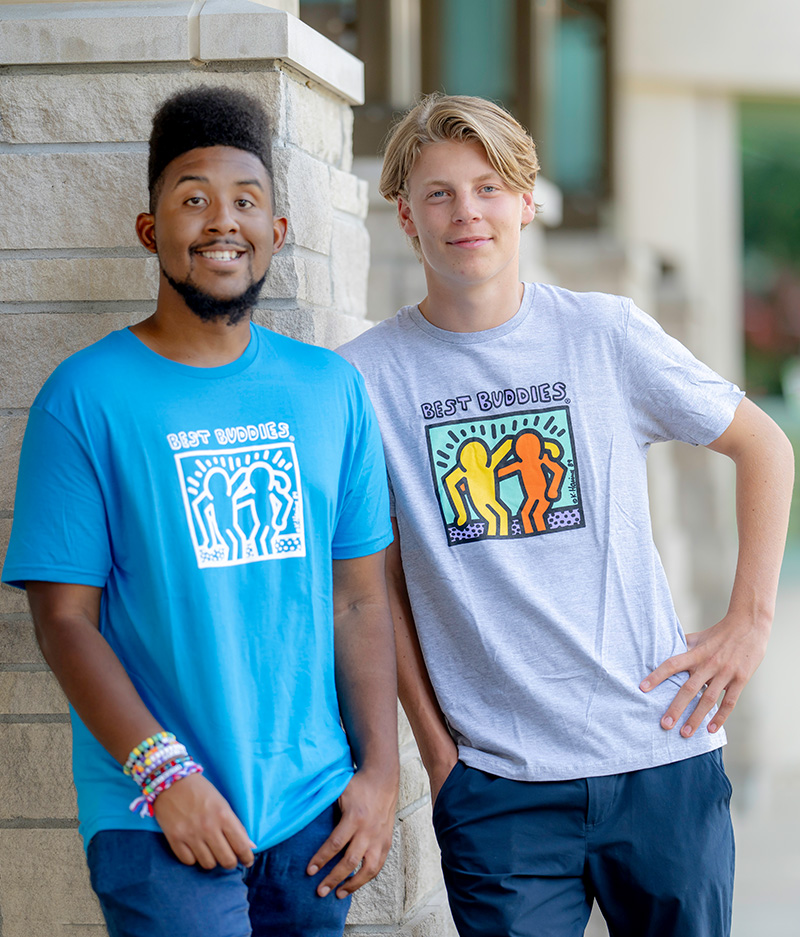 Two male participants with arms over shoulders
