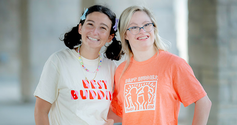 To Best Buddies participants hugging and smiling