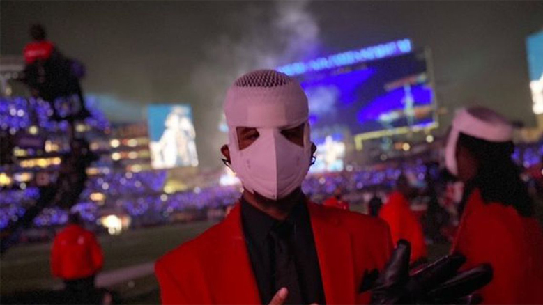 Tampa halftime dancer says autism helped him at the Super Bowl Best Buddies Global Ambassador Joshua Felder, performs as a backup dancer for the Weeknd during the Super Bowl 55 halftime show. He is wearing a red jacket with a white mask.