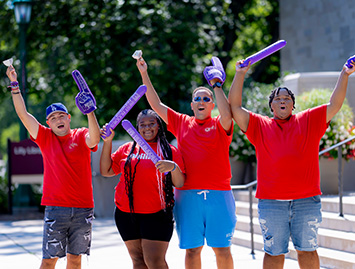 Female Best Buddies participant speaking at a podium at a Best Buddies event